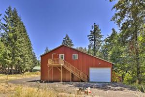 a red barn with a ramp leading to a garage at Oregon City Abode about 23 Mi to Dtwn Portland! in Oregon City