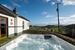 a hot tub in the backyard of a house at The Cottages @ Slievenisky in Ballyward