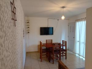 a dining room with a table and chairs and a tv at Apartamentos Santa Rosa 1B in Cordoba