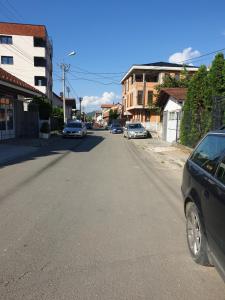 une rue avec des voitures garées sur le bord de la route dans l'établissement Konak, à Novi Pazar