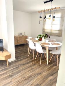 a dining room with a white table and chairs at Appartement en centre - résidence privée, vue mer in Porto-Vecchio