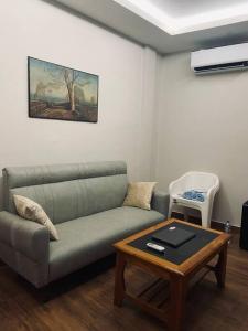 a living room with a couch and a coffee table at SunsetHomes A luxurious studio apartment in Imphal