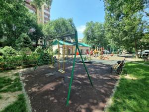 a park with a playground with a swing set at Очень уютная квартира рядом с посольством США in Almaty