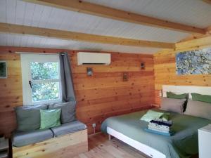 a room with two beds in a log cabin at Chalet Le Petit olivier , gite l Echapée Belle Aubenas in Aubenas +27 photos