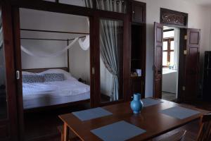 a bedroom with a bed and a wooden table with a table sidx sidx at Sittisang1920 in Kanchanaburi City