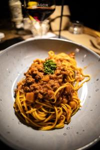 a plate of pasta with meat and sauce at Chalet Hotel Dragon in Breuil-Cervinia