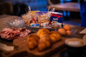 a table with a bunch of food on it at Chalet Hotel Dragon in Breuil-Cervinia +25 photos