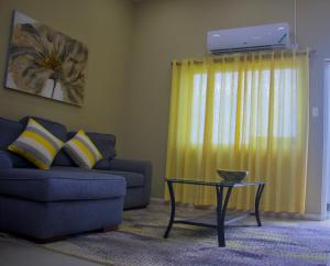 a living room with a couch and a table at Comfort Homes Kingston in Kingston