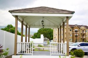 a pavilion in a parking lot with a car at Comfort Homes Kingston in Kingston