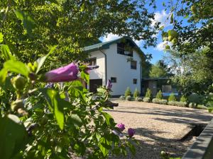 a white house with flowers in front of it at Soko holiday home Bihac in Bihać