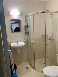 a bathroom with a shower and a toilet and a sink at Свети Йоан in Sozopol +17 photos