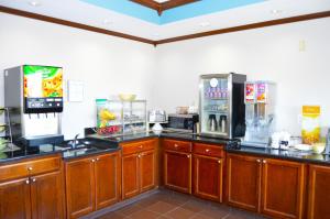 a large kitchen with wooden cabinets and appliances at Quality Inn Coralville - Iowa River Landing in Coralville