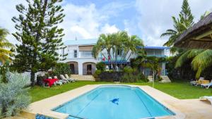 a villa with a swimming pool and a house at Villa Radani in Trou dʼ Eau Douce