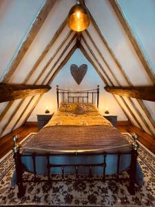 a bedroom with a bed in a attic at Cosy 400yr old Cottage, Flowergate, Whitby, Sleeps 6 in Whitby