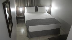 Cama ou camas em um quarto em Essência Hotel Francisco Beltrão
