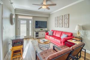 a living room with a red couch and a tv at Fantastic Location! River and Mountain Views 2BR/2BA Sleeps 6 in Pigeon Forge