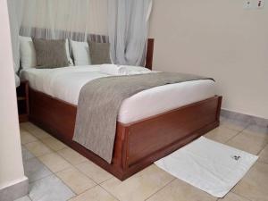 a bed in a room with a mattressvisor at Logmma Regency Hotel in Kakamega