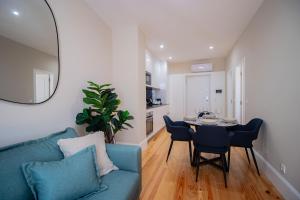 a living room with a blue couch and a table at Almada 1.3 by LovelyStay in Porto