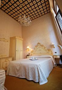 Postel nebo postele na pokoji v ubytování Hotel Torino