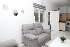 a living room with a couch and a table at Casa La Herradura 1 in Vejer de la Frontera