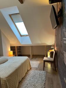 a bedroom with a bed and a skylight at Comfort Zone Ostróda Apartment 1 in Grabinek