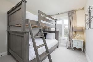 a bedroom with a bunk bed with a ladder at Steps to Blue Mtn Condo wt Elegant Style 213 Sierra Lane in Blue Mountains