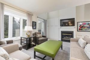 a living room with a couch and a fireplace at Steps to Blue Mtn Condo wt Elegant Style 213 Sierra Lane in Blue Mountains