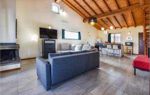 a living room with a couch and a tv and a kitchen at Stunning Home In Castiglione Di S With Wifi And 2 Bedrooms in Solicchiata