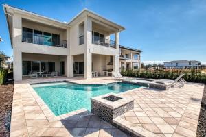 a house with a swimming pool in front of a house at The Bear's Den Resort Orlando in Kissimmee