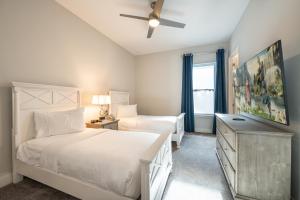 a bedroom with two beds and a ceiling fan at The Bear's Den Resort Orlando in Kissimmee