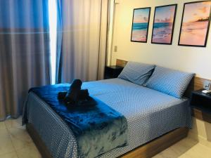 a bedroom with a bed with a stuffed animal on it at Makambira Residence By SummerFlats no CENTRO DE PORTO DE GALINHAS in Porto De Galinhas
