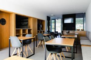 a restaurant with tables and chairs and a couch at Marinhas Bed & Breakfast in Esposende