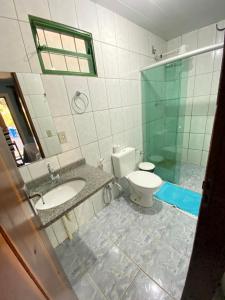a bathroom with a sink and a toilet at Pousada Nenzinha in Sao Jorge +21 photos
