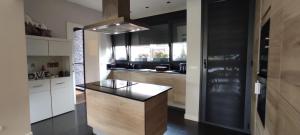 a kitchen with a island in the middle of a room at Ikasmendi in Rentería