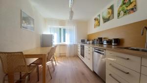 a kitchen with a table and a dining room at Holiday Apartment in Oberveischede