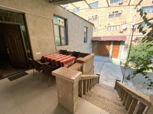 eine Terrasse mit einem Tisch und Stühlen in einem Gebäude in der Unterkunft HovSer in Yerevan