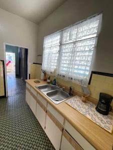 a kitchen with a sink and a window at Casa Libertad in Cayey