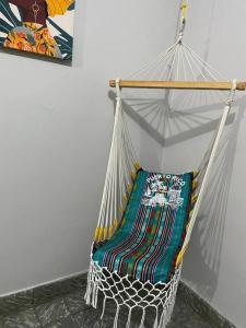 a hammock hanging in a room with a wall at Casa Libertad in Cayey