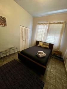 a bedroom with a bed and a window at Casa Libertad in Cayey