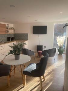 a living room with a table and chairs at Segais Accommodation in Grove