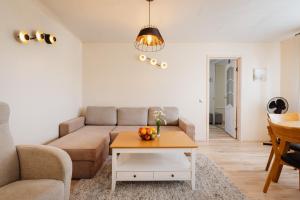 a living room with a couch and a table at Kuuse 4 Apartment with 2 bedrooms in Haapsalu