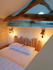 a bedroom with a large bed with wooden headboard at Gite Pays de Joie 