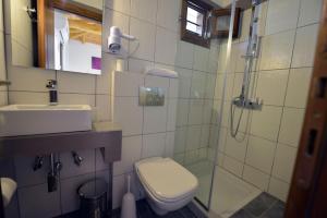 a bathroom with a toilet and a sink and a shower at Haus Katerina in Vourvourou