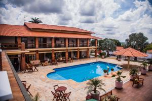 an image of a hotel with a swimming pool at Hotel Imperium Village in Sarapuí