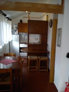 a kitchen and dining room with a table and chairs at Apartment Old Town in Pula