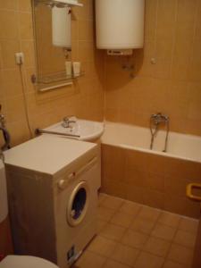 a bathroom with a sink and a washing machine at Apartment Old Town in Pula