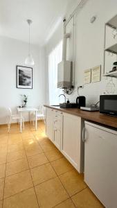 a kitchen with a counter and a table in a room at Christie's Downtown Apartment in Budapest