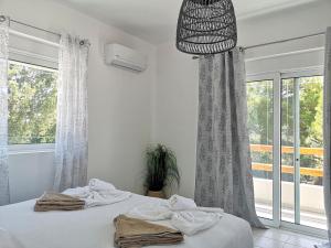 a bedroom with a bed and a large window at Chrysanthi Villa, Living in Nature in vlicha