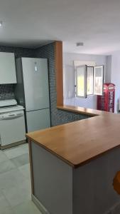 a kitchen with a counter top and a refrigerator at TRIPLEX DE LUJO EN MOJACAR in Mojácar