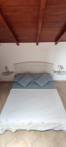 a bedroom with a white bed with two pillows at Sal Service new studio penthouse in Santa Maria